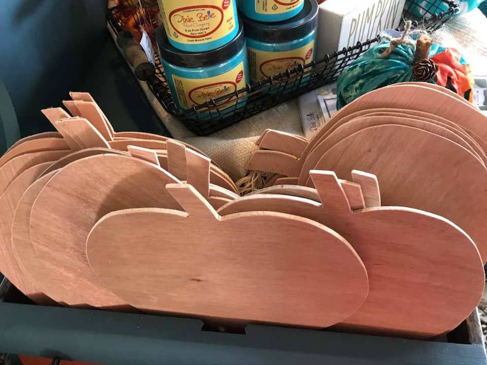 Wooden pumpkin cutouts ready for teal paint