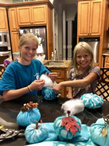 Julie and Emma sewing the teal pumpkins