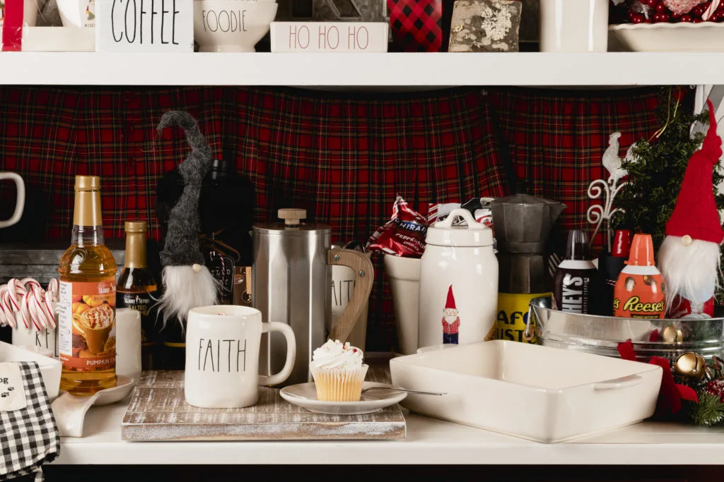 A shelf with coffee making items and a cupcake