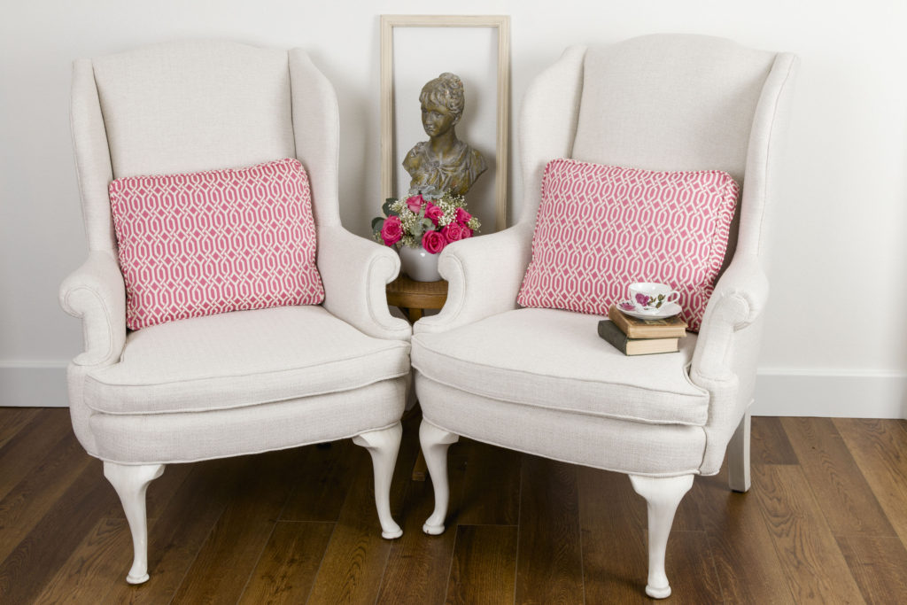 Wingback Chairs with Pink Geometric Pillows 