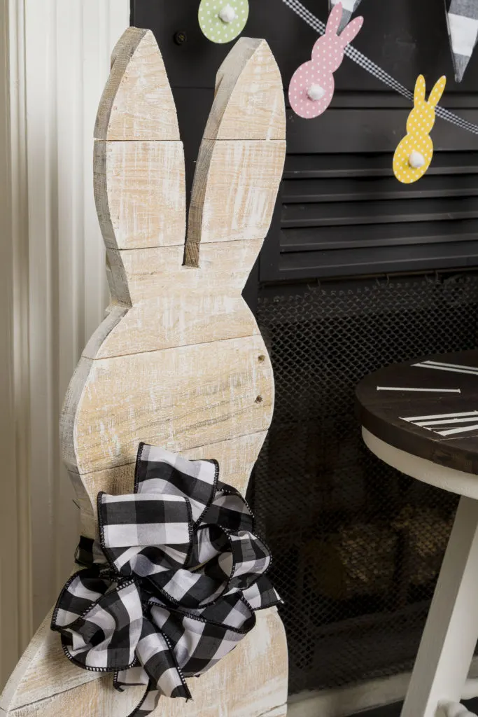 Standing Mr. Bunny with buffalo check bow, bunny banner, bunny pillow, flower pots