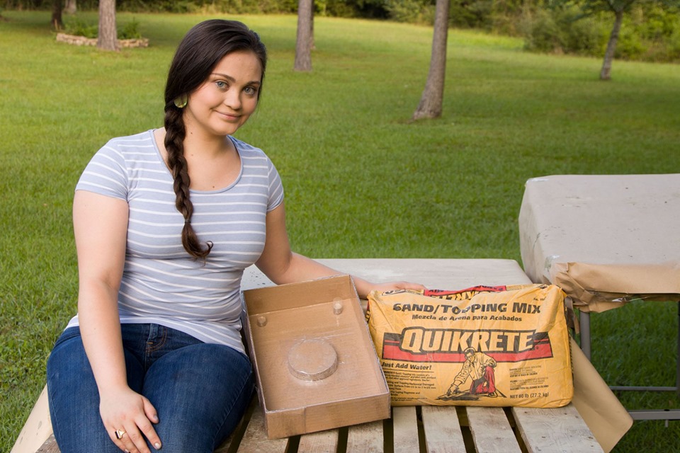 Olivia with a bag of quikrete and her form