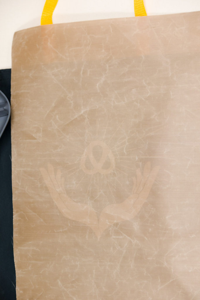 Place the Teflon sheet over the vinyl design before pressing. Making a canvas tote bag is easy and fast.... Placing the Teflon sheet on top of design before ironing