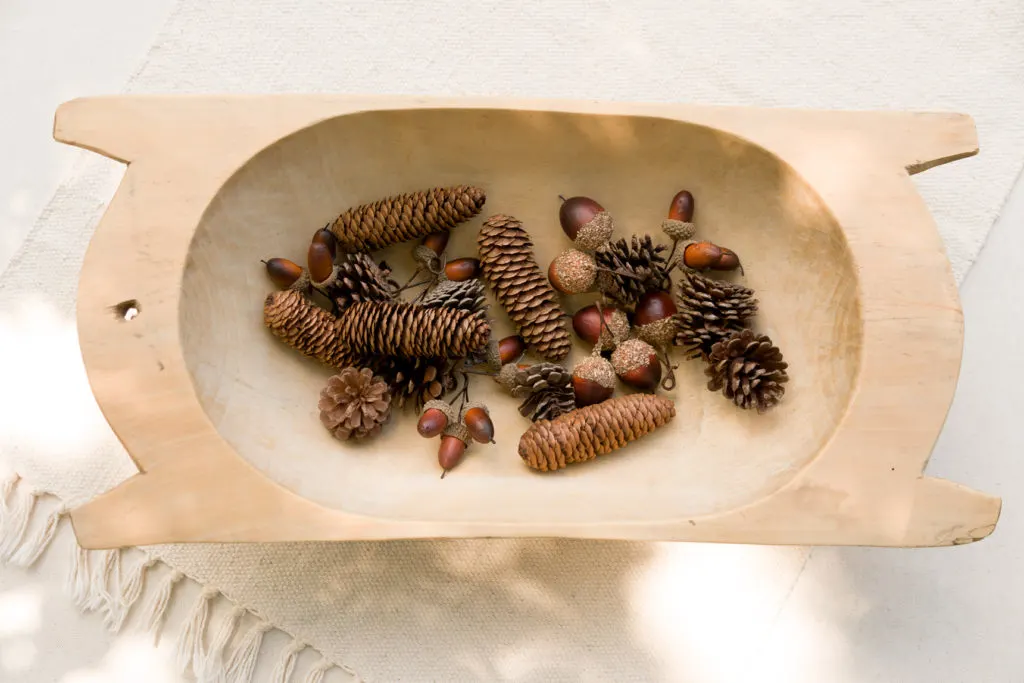 Vintage dough bowl with pine cones and acorns