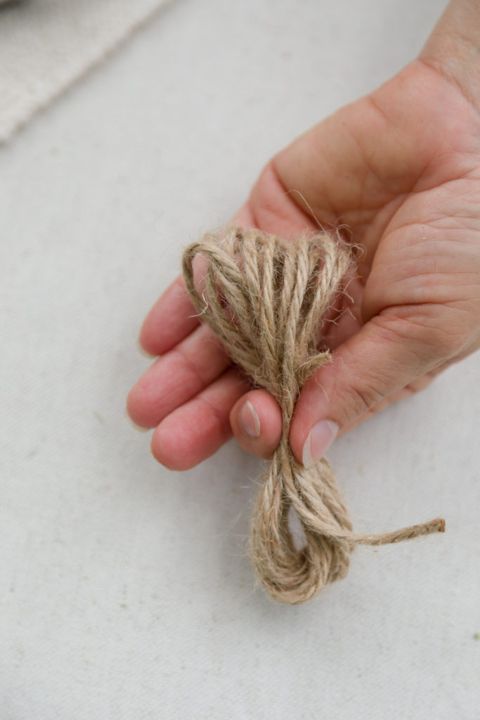 Holding the bow loops of twine 