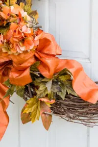 Easy one ribbon bow on pumpkin wreath was quick to make. Decorate your front door with a fall wreath. Welcome guests and fall with a handmade wreath and bow. Learn how easy it is to make one today. Gorgeous fall bow