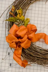 Adding the pumpkin floral pick