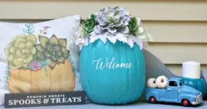Teal-Pumpkin-Project-succulent-pumpkin-on-porch-with-pillow-and-small-truck