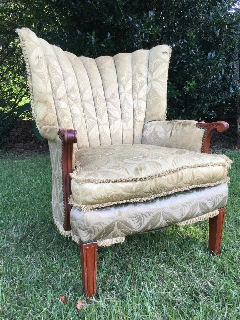 Worn, water stained, and tattered loop fringe on chair upholstery