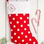 Handmade Christmas stocking red with white polka dots and a white cuff and a name tag