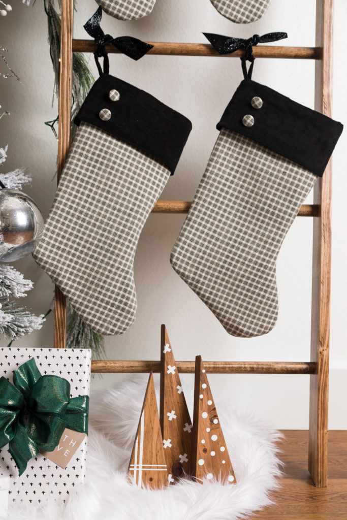 handmade Christmas stockings displayed on the wood blanket ladder