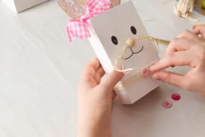 Adding a pink button to the reclaimed wood Easter Bunny