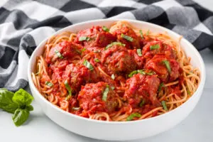 Tomato sauce served over meatballs and spaghetti