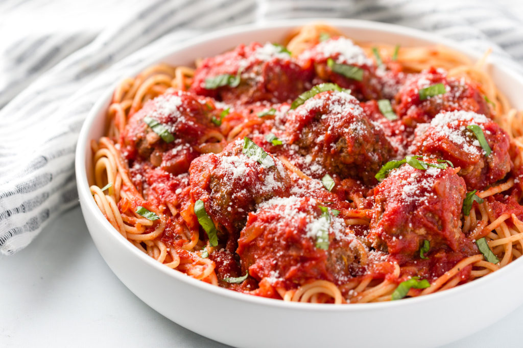 Marinara sauce over meatballs and spaghetti