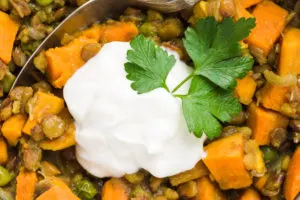 Serve curry lentil stew with sour cream and cilantro