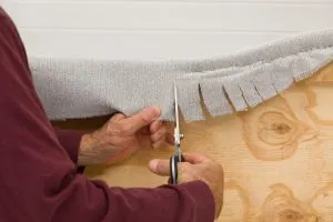 In the curved areas make relief cuts to make the fabric follow the contour of the headboard.