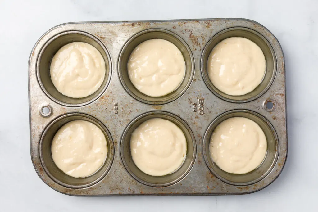 Fill muffin tins with half the muffin batter