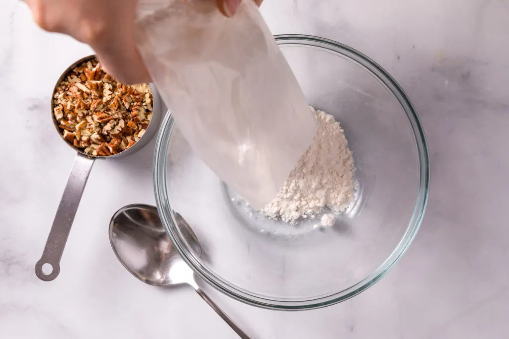 Dump the cake mix and chopped nuts in a bowl