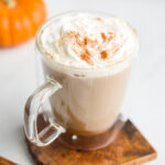 Latte garnished with whipped cream and pumpkin spice