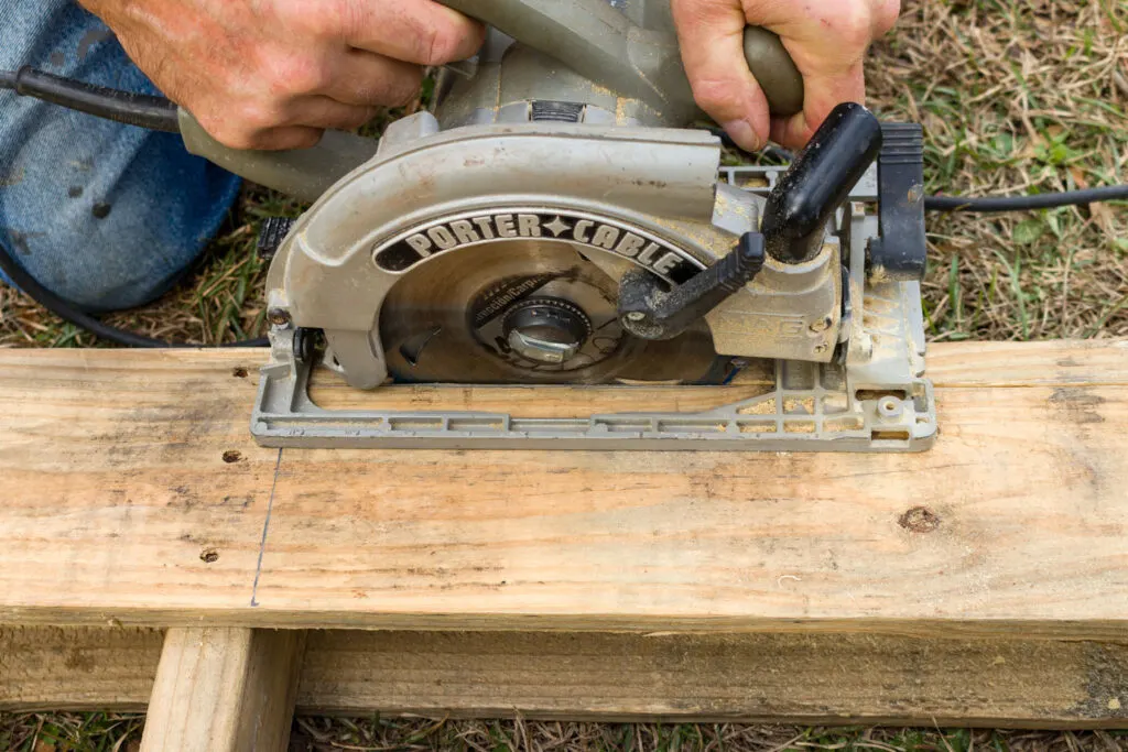 Using a skil saw to cut the pallet
