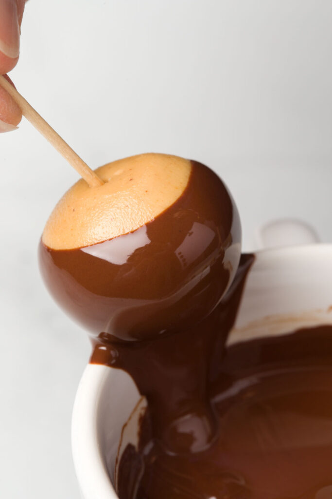 Dip peanut butter balls into the melted chocolate