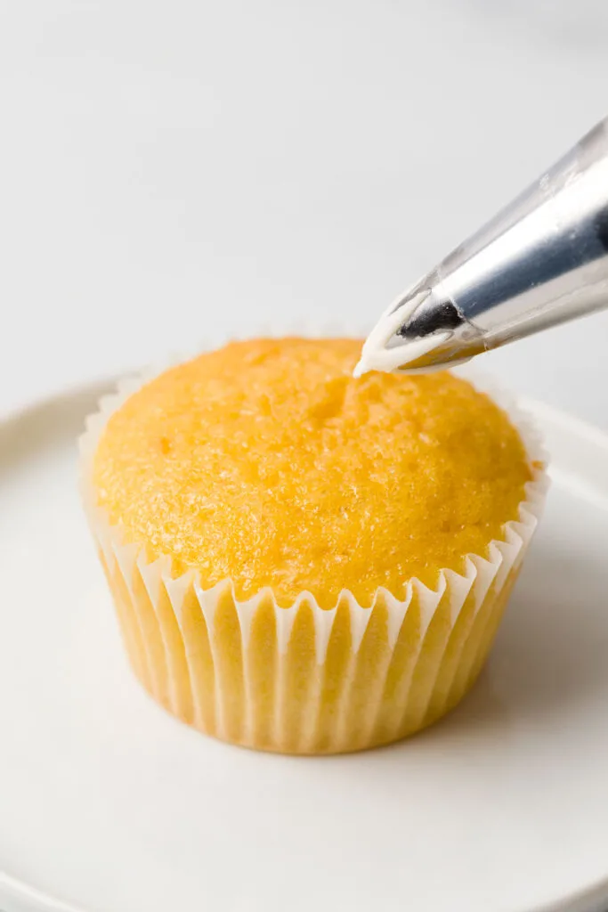 Frosting cupcakes with pastry bag