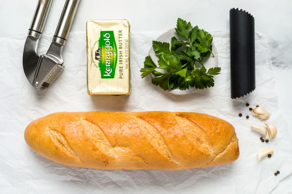 Bread, butter, garlic cloves, and parsley 