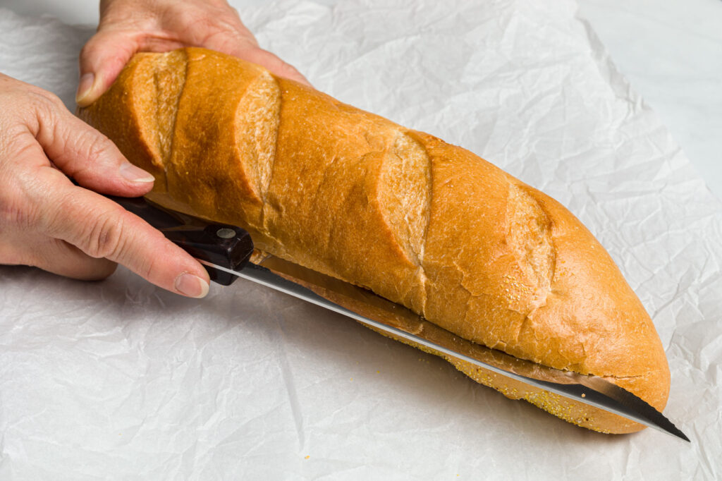 Slicing the bread in half lengthwise