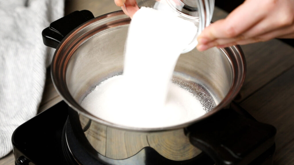 Placing sugar in a saucepan