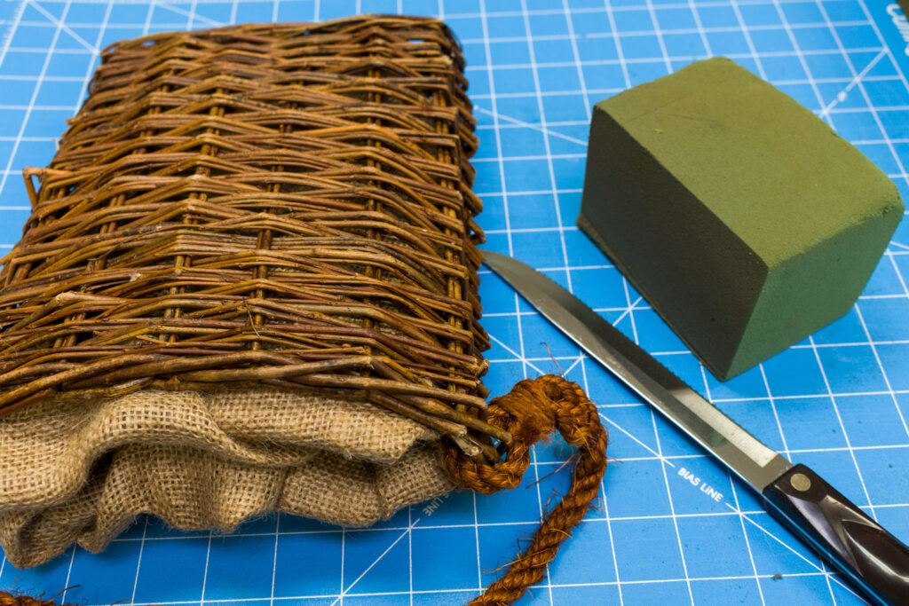 Basket, floral foam and bread knife Basket, floral foam and bread knife