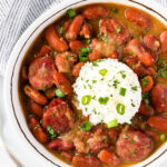 Red beans and rice in a bowl with chopped green onions for garnish