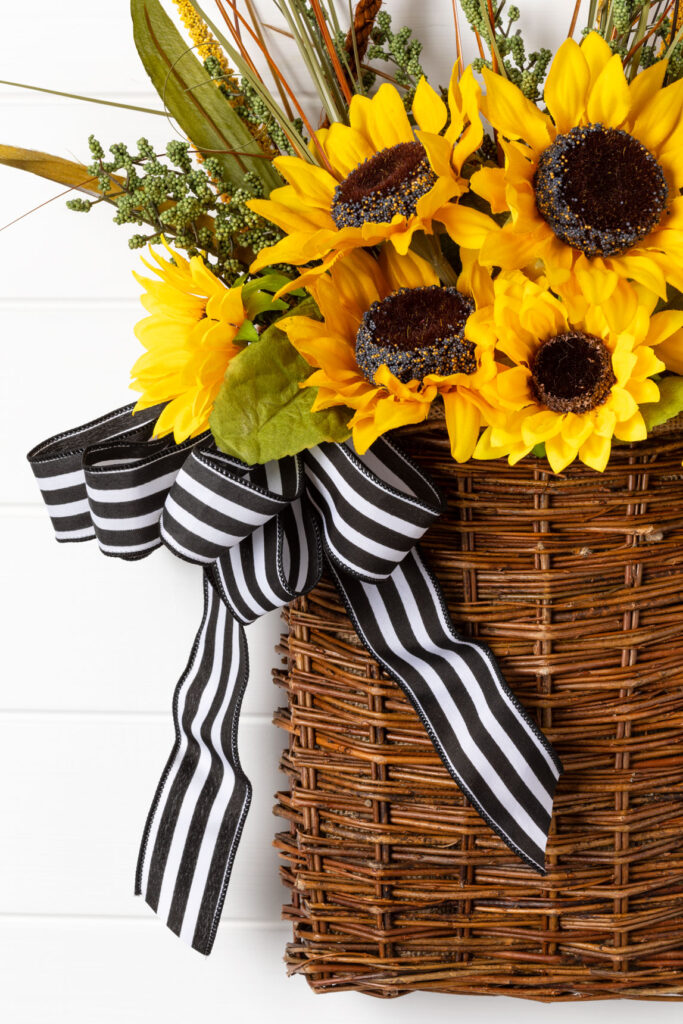 Attach bow to basket The flower basket with bow