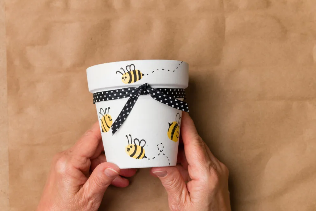 Finished painted pot with bees and polka dot ribbon