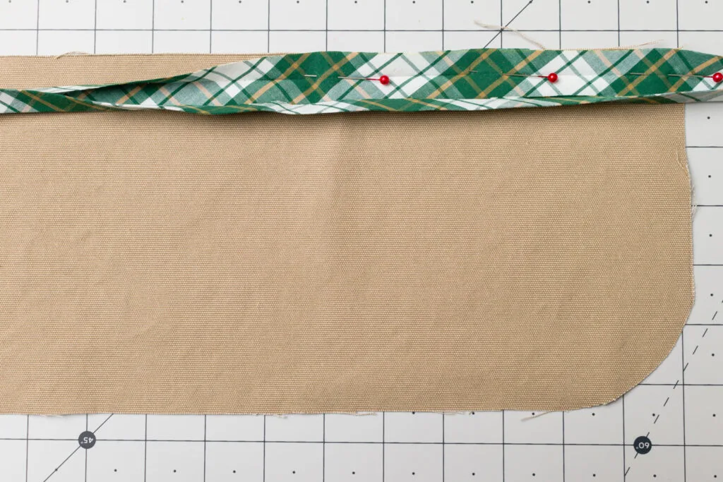 Pin the bias tape to the top pocket edge