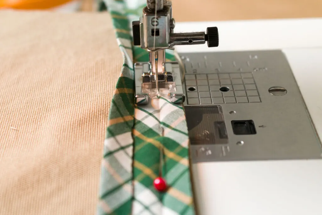 Sew the bias tape to the top edge of the pocket