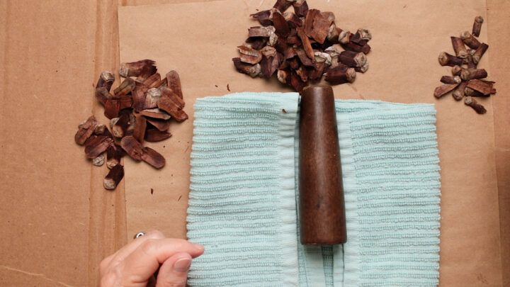 Folding tea towel with the furniture table and three piles of pine cone scales