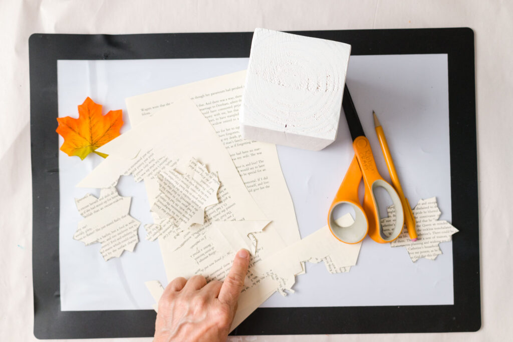 Cutting a leaf shape out of book pages