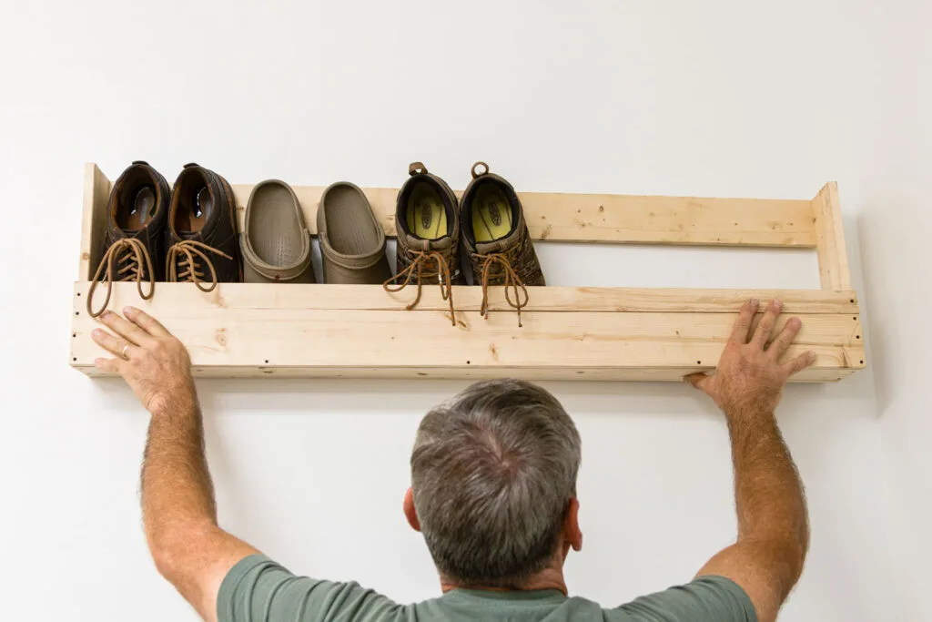 holding up a finished shoe rack to decide placement