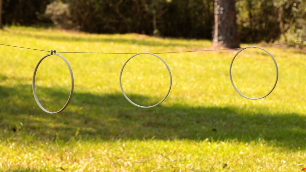 Embroidery hoops outside hanging on twine 