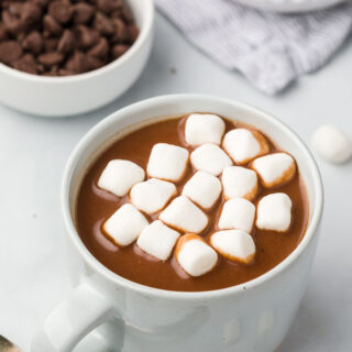 Crockpot hot chocolate in a mug topped with marshmallows