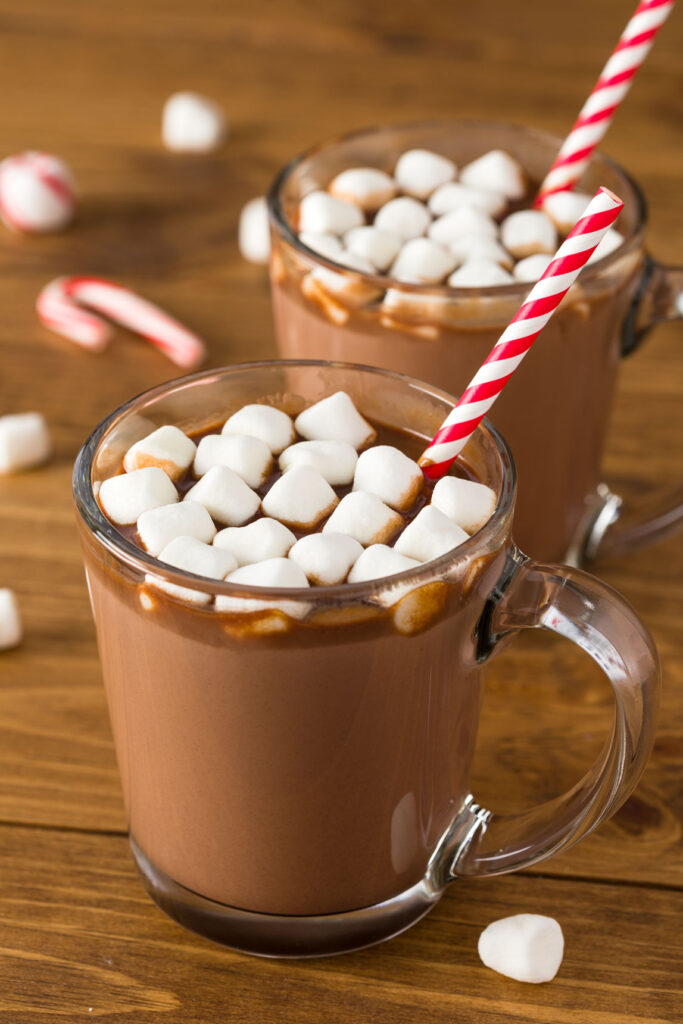 Hot chocolates in a clear glass mugs topped with marhmallows