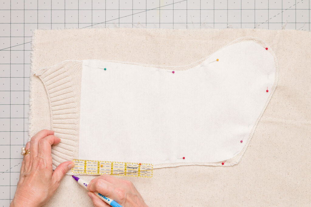 Stocking pinned to the lining, marking the 1/2 inch seam allowance for the lining upper edge