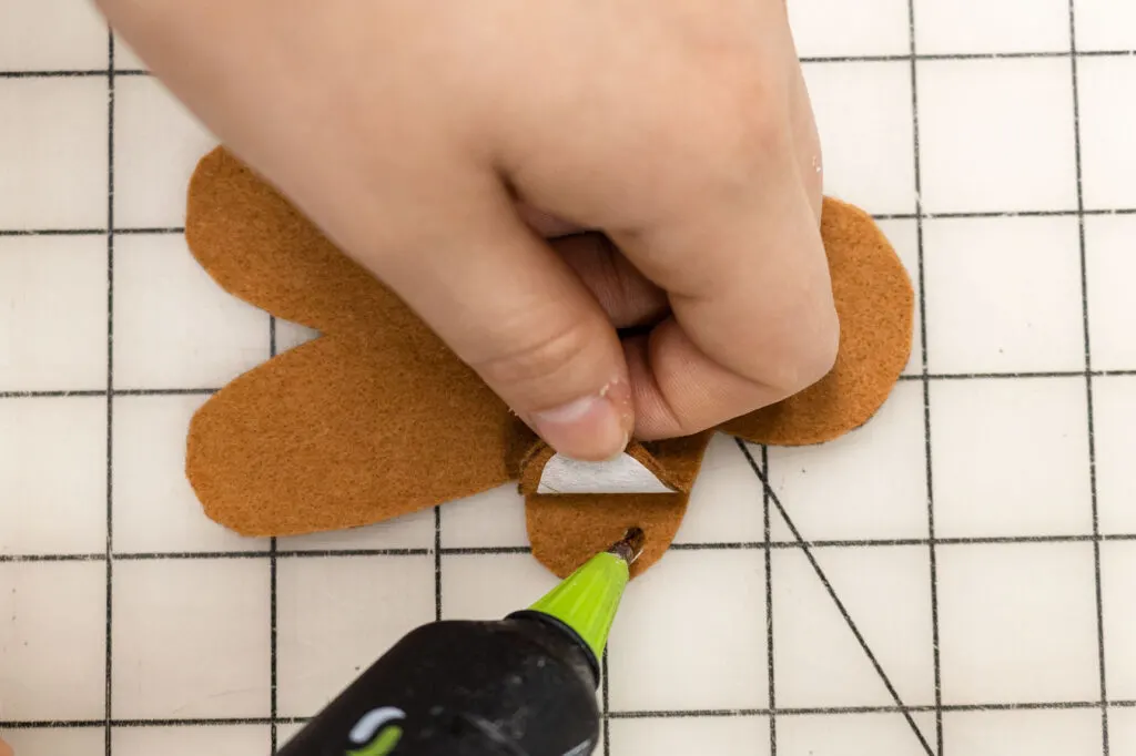 Attaching the gingerbread front and back pieces together with hot glue
