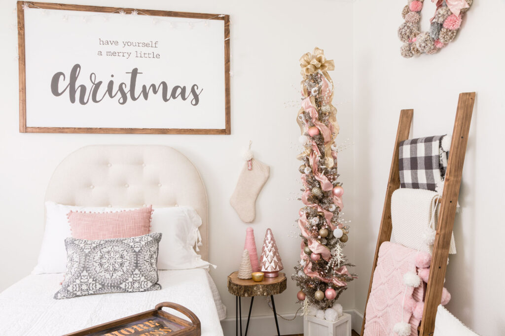 Bedroom with pink and gold Christmas decorations and pretty tree
