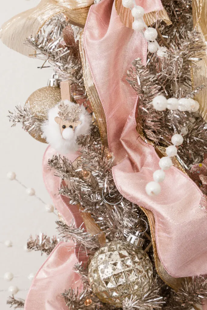 Christmas ornaments on a rose gold tinsel tree