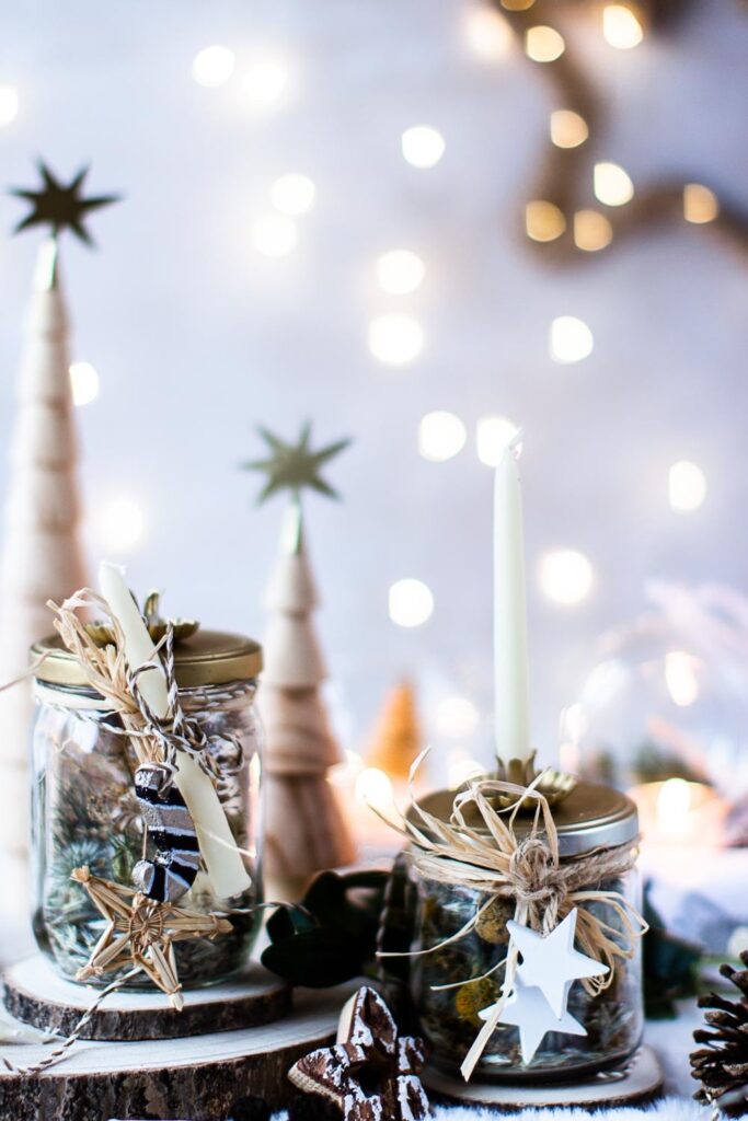 Handmade candle holders with salt dough stars displayed with wooden trees and fairy lights