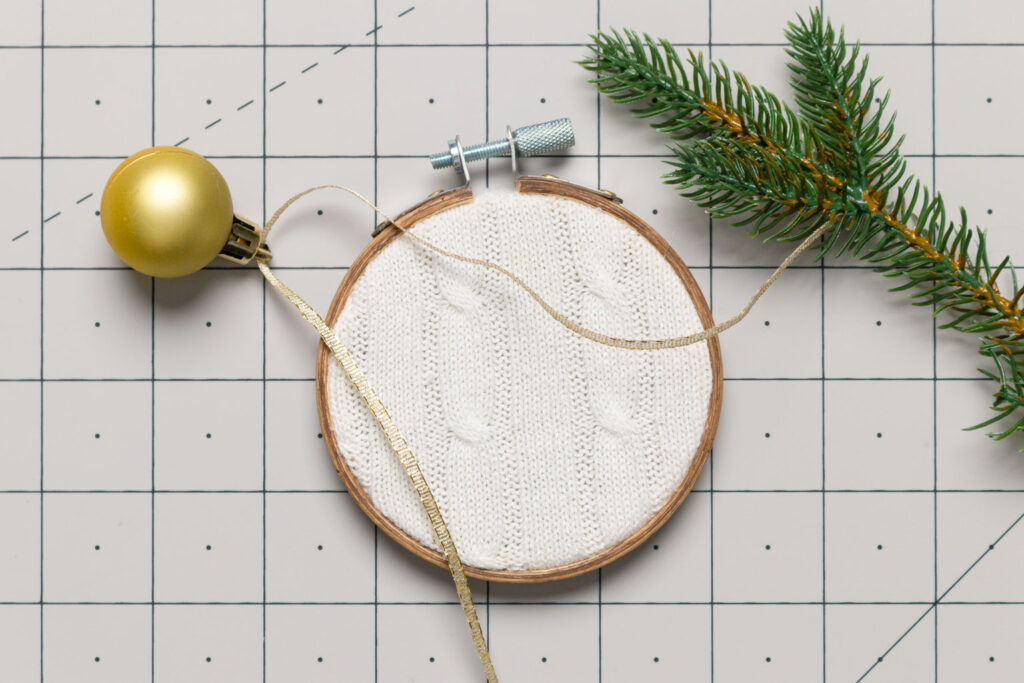 Supplies (mini gold bulb, ribbon and greenery to decorate the embroidery hoop ornament