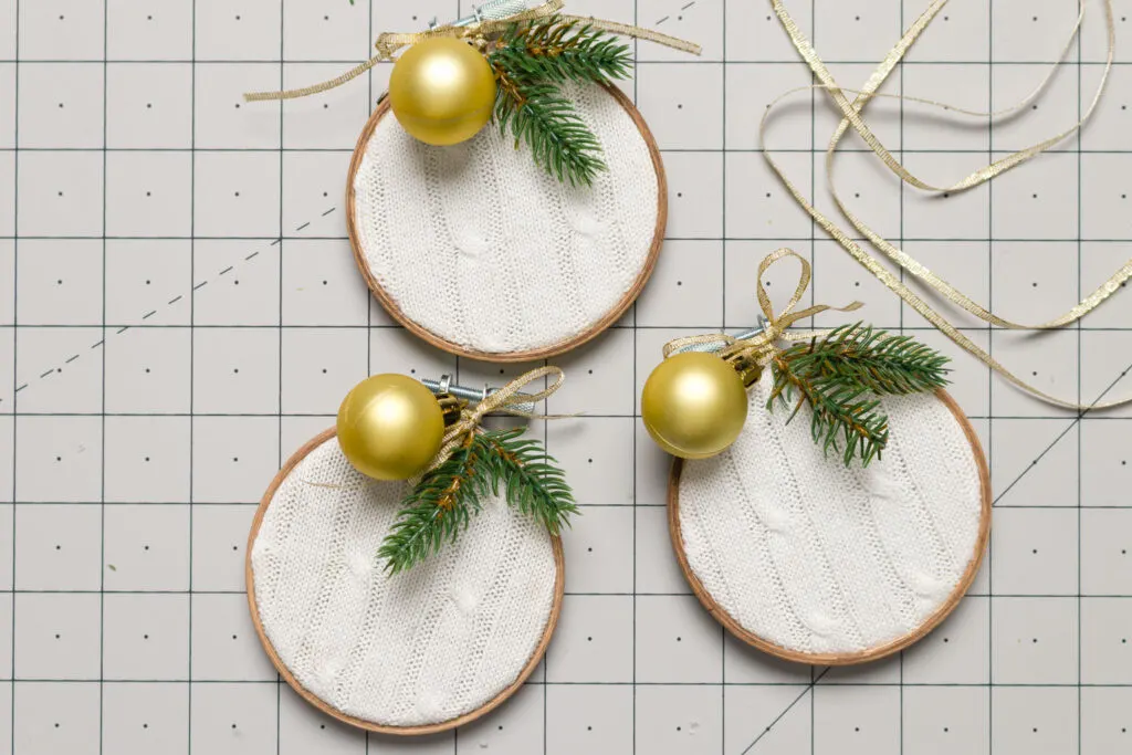 Finished sweater ornaments on a cutting mat