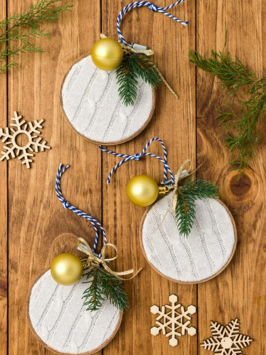 White sweater embroidery hoop ornaments sitting on a wood table