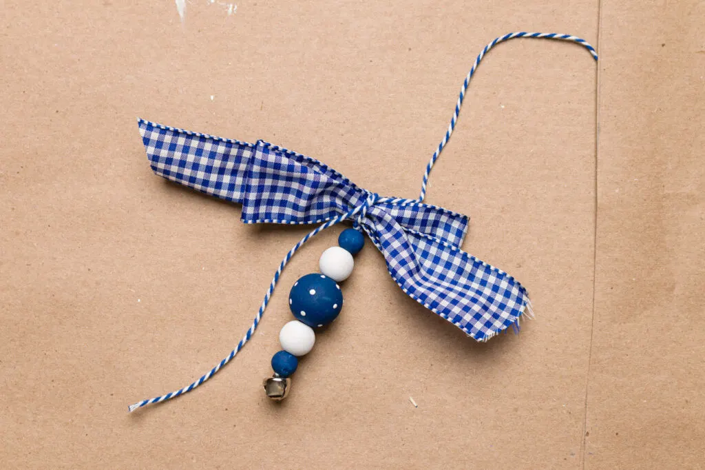 Tie the simple gingham ribbon bow to the ornament with the baker's twine